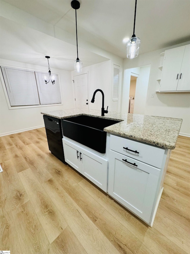 kitchen with pendant lighting, light hardwood / wood-style floors, white cabinets, and black dishwasher