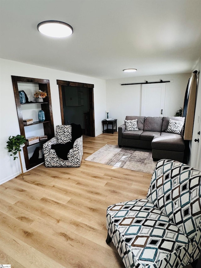 living room with hardwood / wood-style floors and a barn door