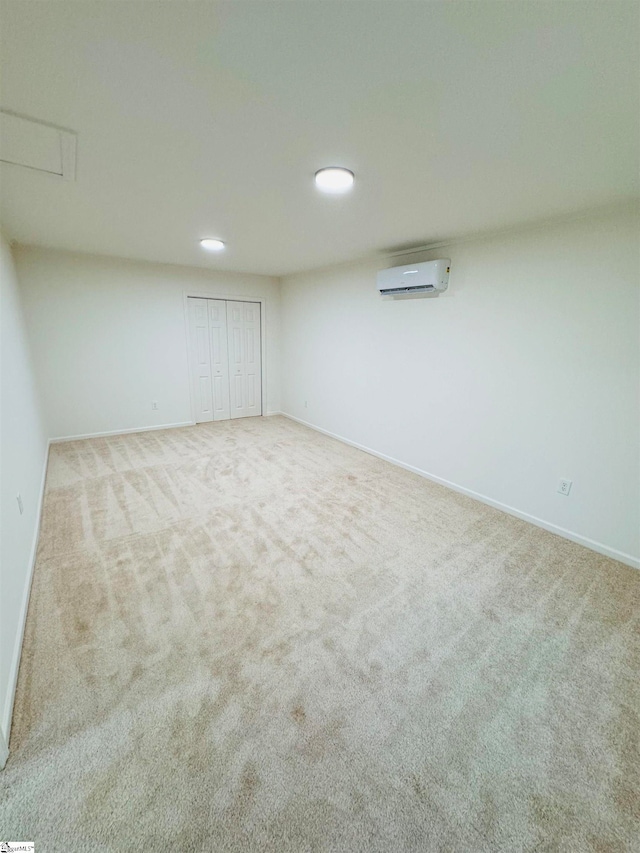 interior space featuring an AC wall unit and light carpet