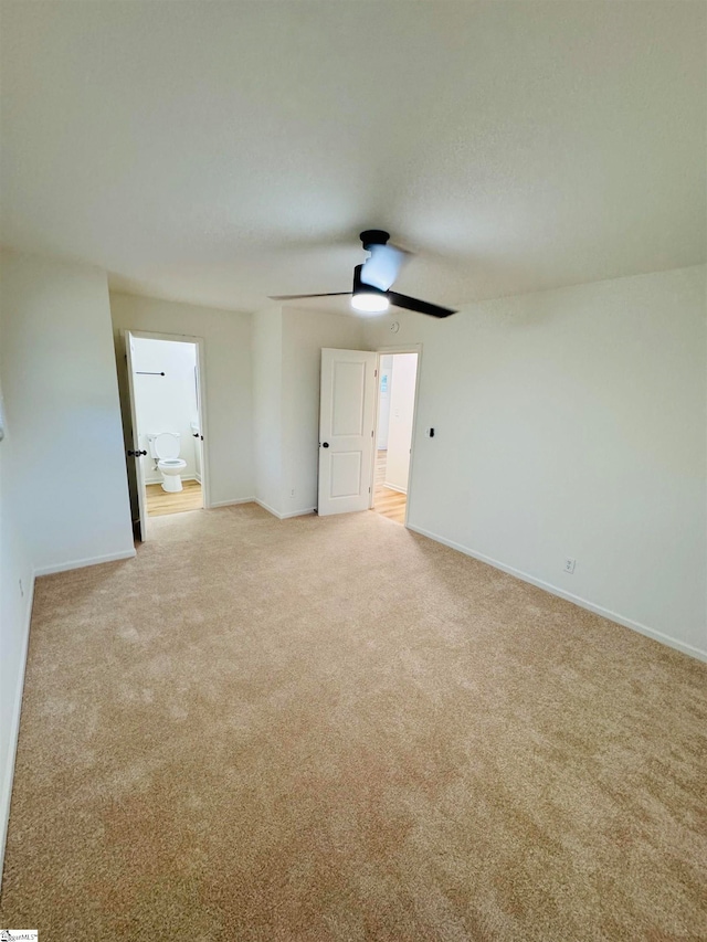 unfurnished room with ceiling fan and light carpet