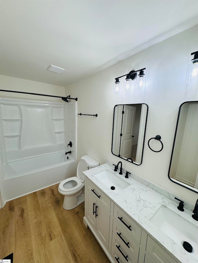 full bathroom with hardwood / wood-style flooring, vanity, toilet, and bathtub / shower combination