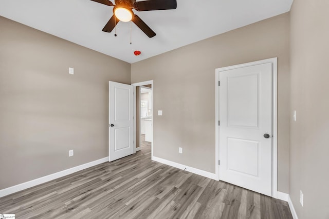 unfurnished bedroom featuring ceiling fan and light hardwood / wood-style floors