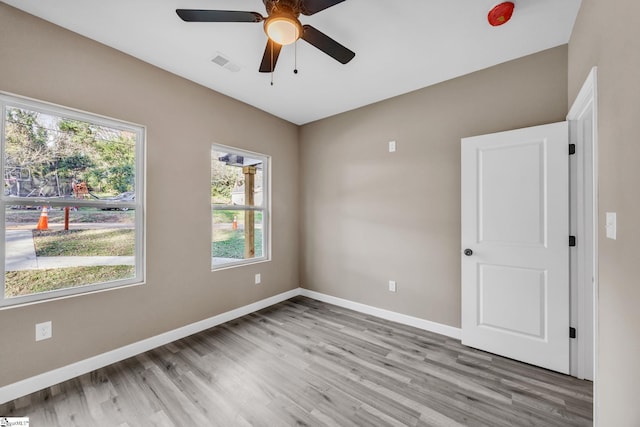 unfurnished room featuring ceiling fan and light wood-type flooring