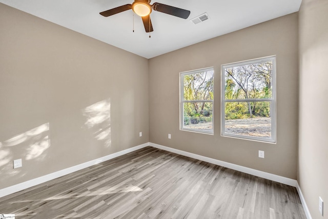 spare room with ceiling fan and light hardwood / wood-style floors