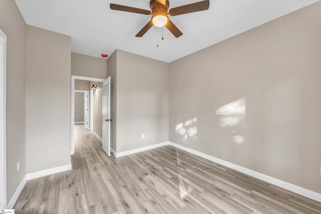 empty room with ceiling fan and light hardwood / wood-style floors