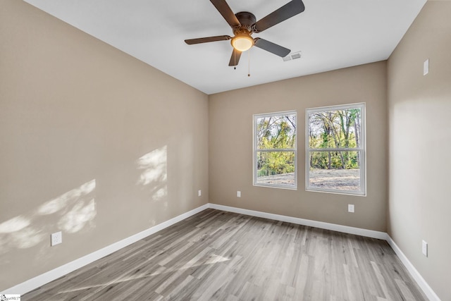 unfurnished room with light wood-type flooring and ceiling fan