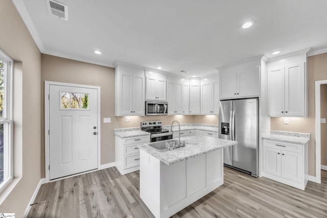 kitchen featuring white cabinetry, sink, light wood-type flooring, and appliances with stainless steel finishes