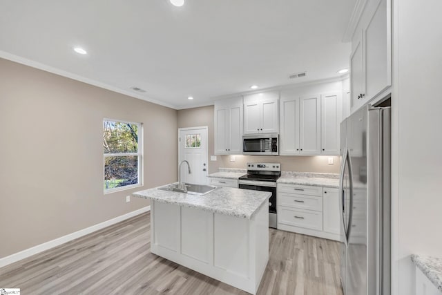 kitchen with appliances with stainless steel finishes, sink, a center island with sink, light hardwood / wood-style flooring, and white cabinets