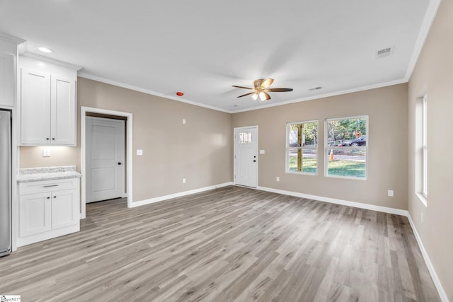 unfurnished living room featuring light hardwood / wood-style flooring, ceiling fan, and crown molding