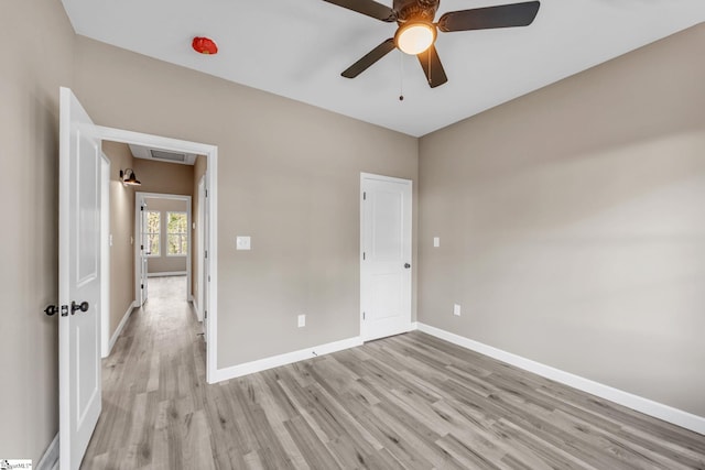 spare room with light wood-type flooring and ceiling fan