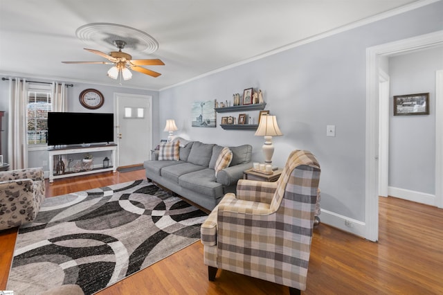 living room with hardwood / wood-style floors, ceiling fan, and crown molding