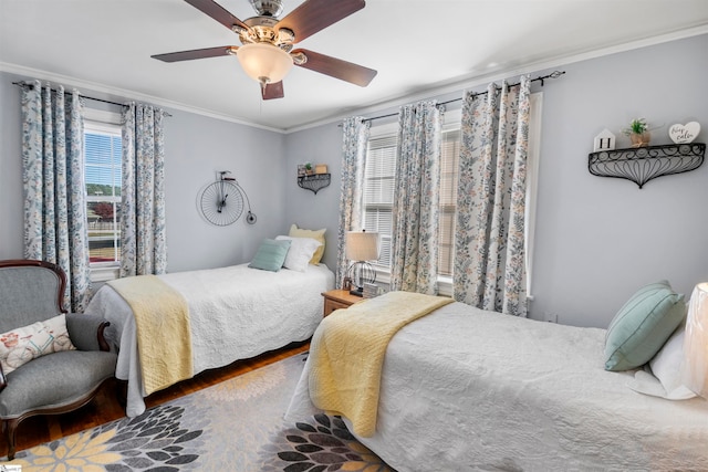 bedroom featuring hardwood / wood-style flooring, ceiling fan, and ornamental molding