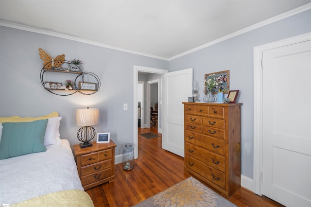 bedroom featuring crown molding and dark wood-type flooring