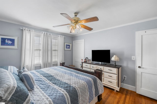 bedroom with ceiling fan, dark hardwood / wood-style flooring, and ornamental molding