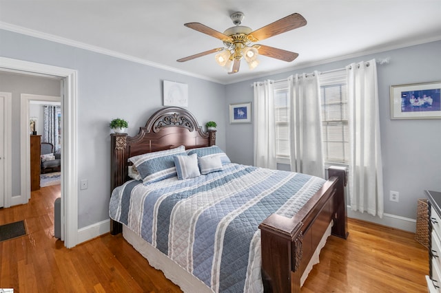 bedroom featuring ceiling fan, light wood-type flooring, and crown molding