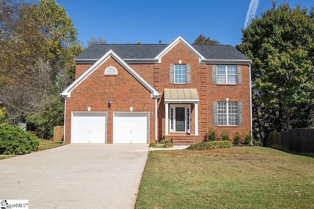 view of front of home featuring a garage and a front lawn