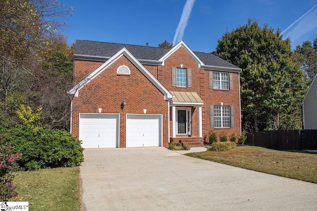 view of front of home with a front lawn and a garage