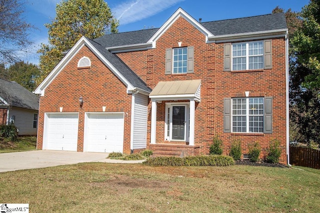 view of front of house with a front lawn and a garage