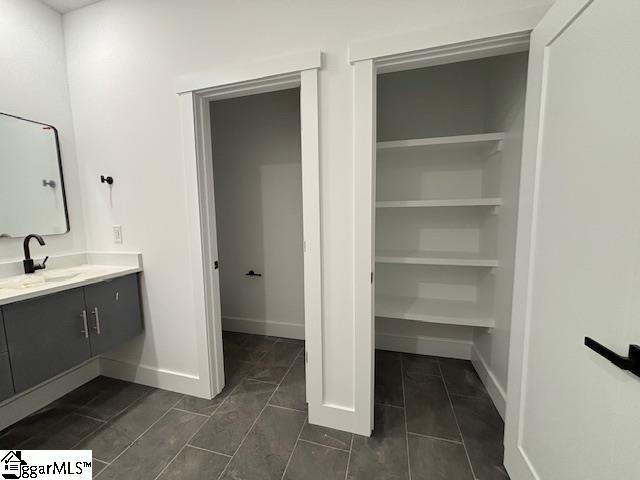 bathroom with vanity and baseboards