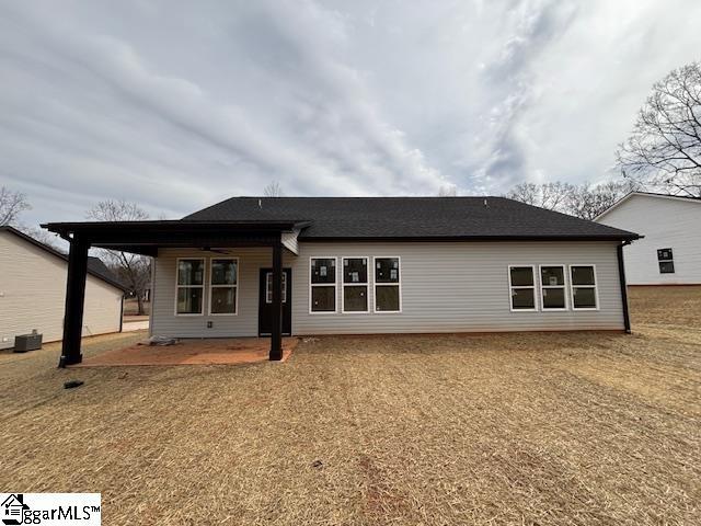 rear view of house with a ceiling fan and a patio