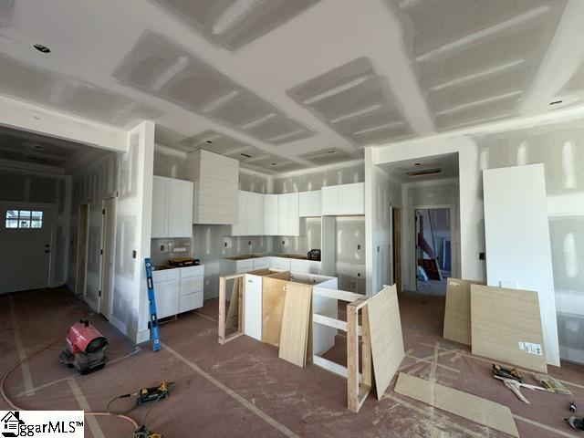 kitchen with a kitchen island and white cabinetry