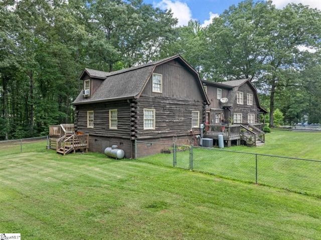 rear view of property with central AC, a lawn, and a wooden deck