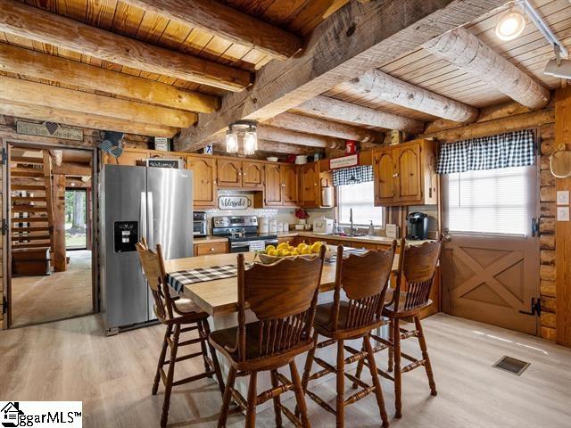 kitchen featuring a healthy amount of sunlight, light hardwood / wood-style floors, and appliances with stainless steel finishes