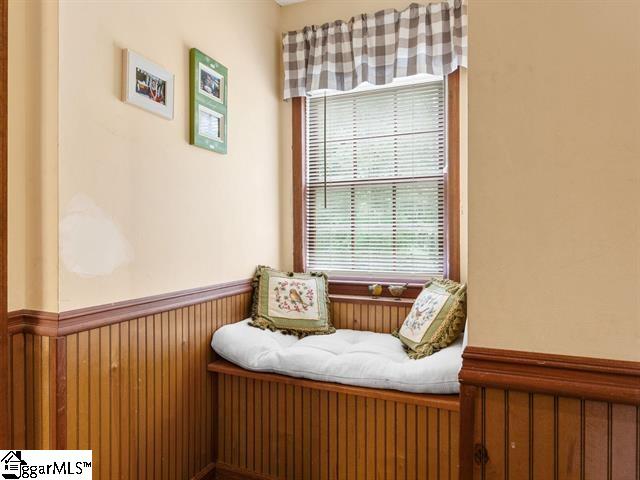 sitting room featuring wooden walls