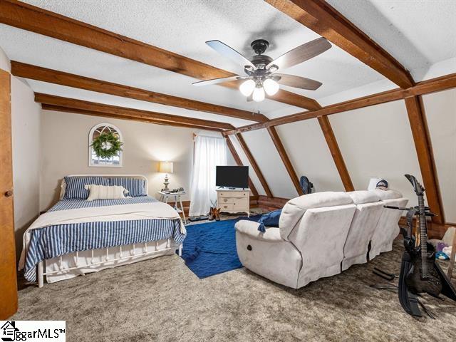 carpeted bedroom featuring ceiling fan, lofted ceiling with beams, and a textured ceiling