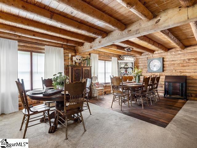 dining area with beam ceiling, wood ceiling, and hardwood / wood-style flooring