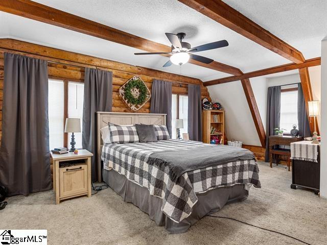 bedroom featuring multiple windows, ceiling fan, and light carpet