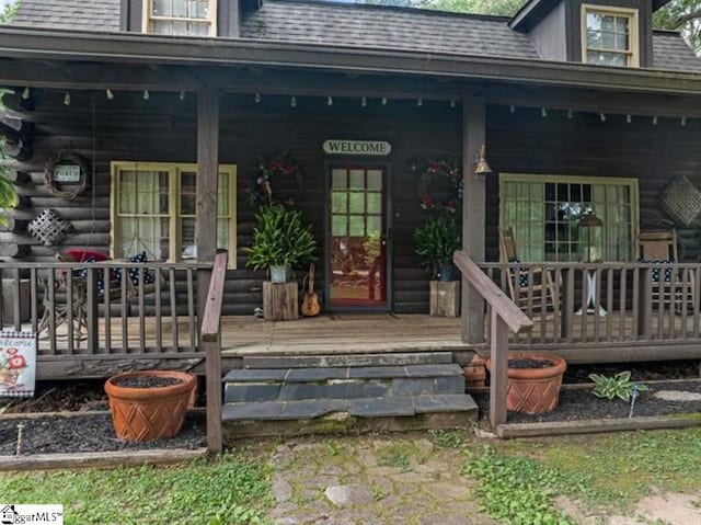 doorway to property featuring covered porch