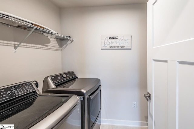 clothes washing area featuring washing machine and clothes dryer