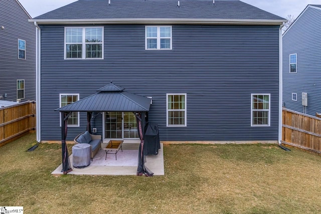 rear view of property featuring a gazebo, a lawn, and a patio