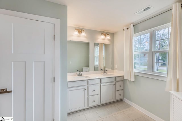 bathroom with vanity, tile patterned floors, and a healthy amount of sunlight