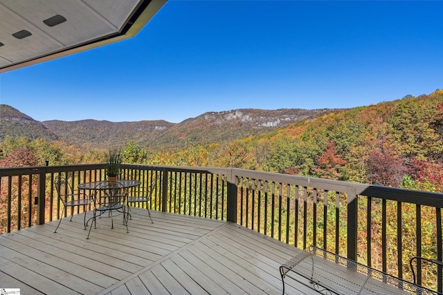 wooden deck with a mountain view