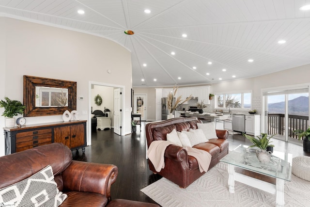 living room with dark hardwood / wood-style floors, a mountain view, wooden ceiling, and high vaulted ceiling