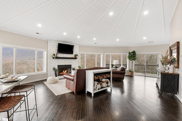 living room featuring dark hardwood / wood-style floors, a healthy amount of sunlight, wooden ceiling, and a fireplace