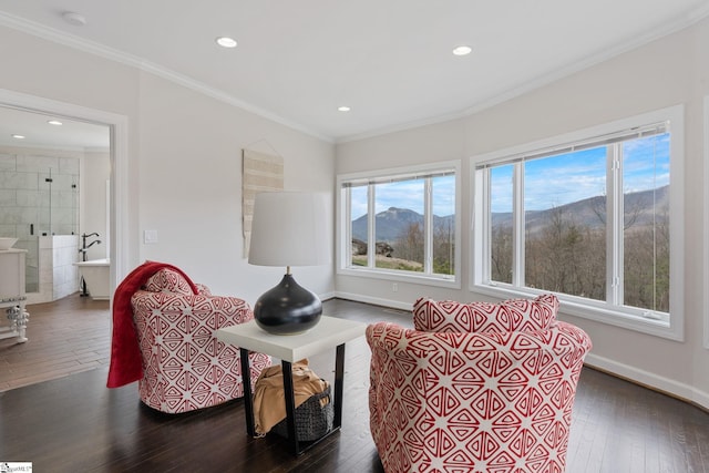 living room with a mountain view, dark hardwood / wood-style flooring, tile walls, and crown molding