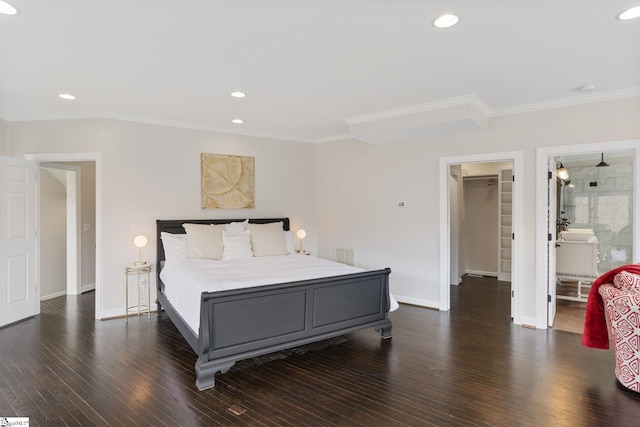 bedroom with dark wood-type flooring, crown molding, ensuite bath, a spacious closet, and a closet