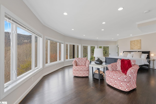 interior space with dark hardwood / wood-style floors, crown molding, and a healthy amount of sunlight