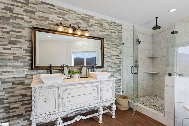 bathroom featuring vanity, an enclosed shower, wood-type flooring, and ornamental molding