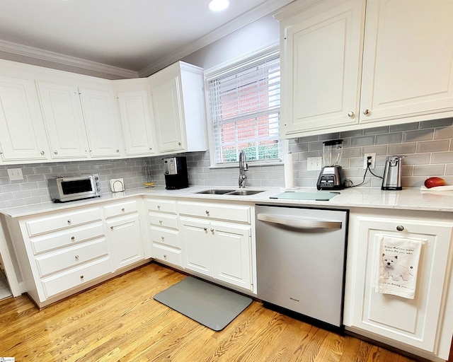 kitchen with dishwasher, crown molding, sink, light hardwood / wood-style flooring, and white cabinetry