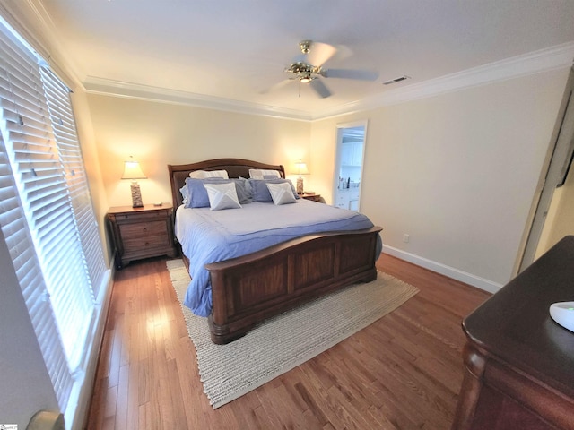 bedroom featuring ceiling fan, ornamental molding, and hardwood / wood-style flooring