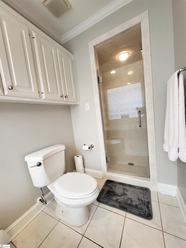 bathroom featuring tile patterned flooring, toilet, an enclosed shower, and crown molding