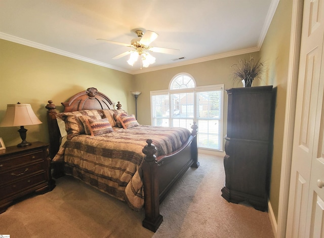 bedroom featuring carpet, ceiling fan, crown molding, and a closet