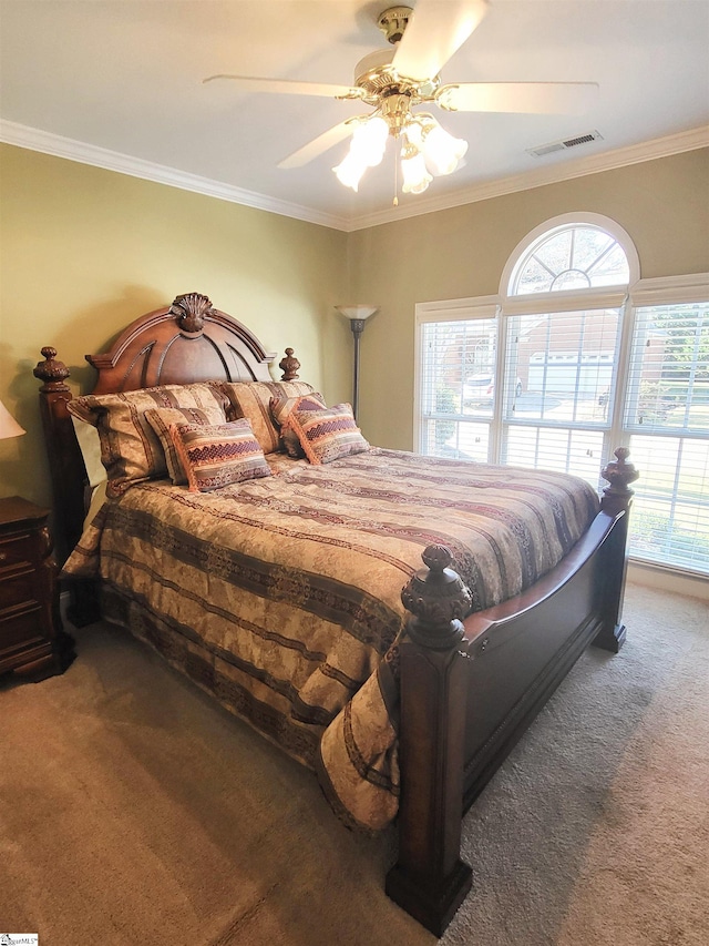 carpeted bedroom with ceiling fan and crown molding