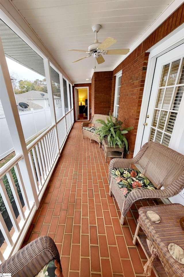 sunroom / solarium featuring ceiling fan