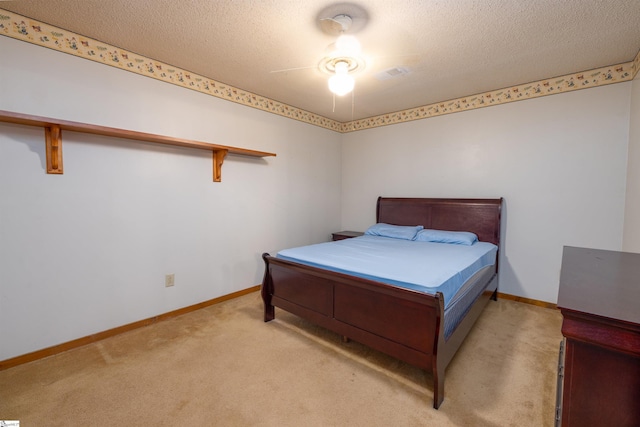 bedroom with light carpet, a textured ceiling, and ceiling fan