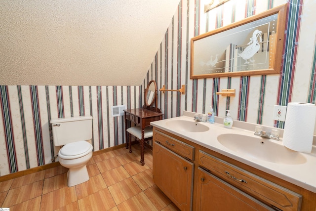 bathroom with tile patterned flooring, vanity, and toilet